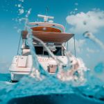 Sea Monkey 50 ft Sea Ray yacht seen from the water with splash and Caribbean sky – I Live Where You Vacation | Yate Sea Monkey de 50 pies Sea Ray visto desde el agua con salpicadura y cielo caribeño – I Live Where You Vacation