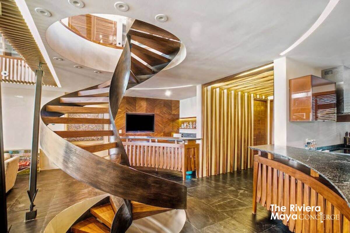 Villa Gulf’s handcrafted spiral staircase and warm wooden finishes create an atmosphere of elegance and sophistication curated by I Live Where You Vacation. | La escalera de caracol artesanal y los acabados de madera de Villa Gulf crean una atmósfera de elegancia y sofisticación curada por I Live Where You Vacation.
