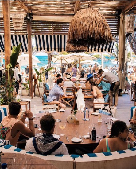 A vibrant atmosphere at Bagatelle Tulum, where fine dining meets beachside celebration — Mediterranean flair, ocean breeze, and luxury hospitality in the heart of the Riviera Maya. | Una atmósfera vibrante en Bagatelle Tulum, donde la alta gastronomía se fusiona con la celebración junto al mar — estilo mediterráneo, brisa marina y hospitalidad de lujo en el corazón de la Riviera Maya.
