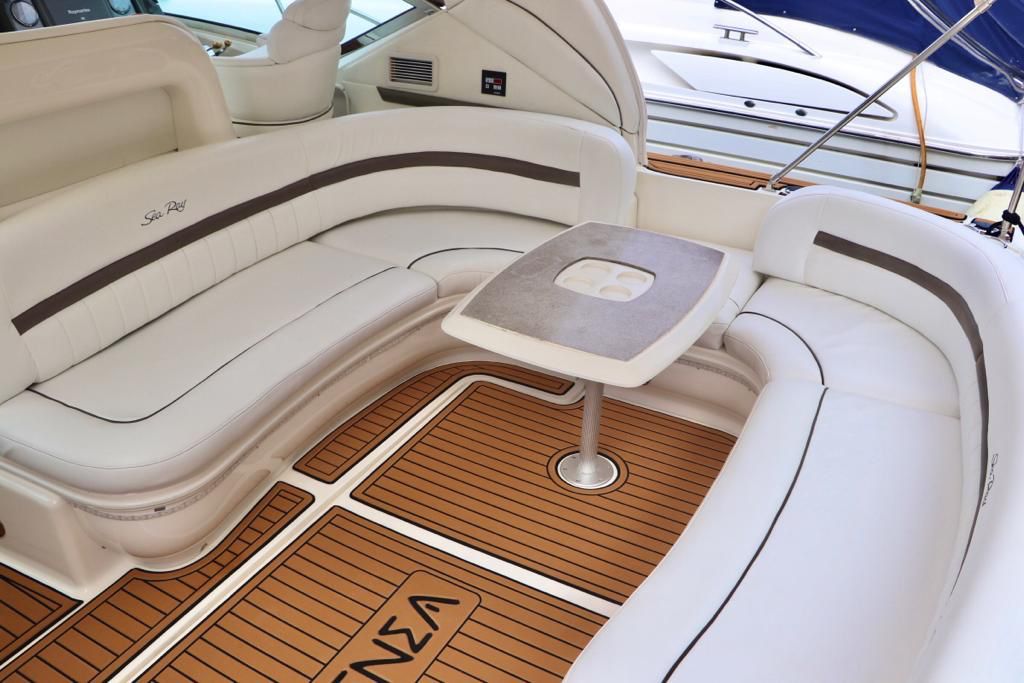 Cockpit lounge with curved seating and table aboard Atenea 46ft
