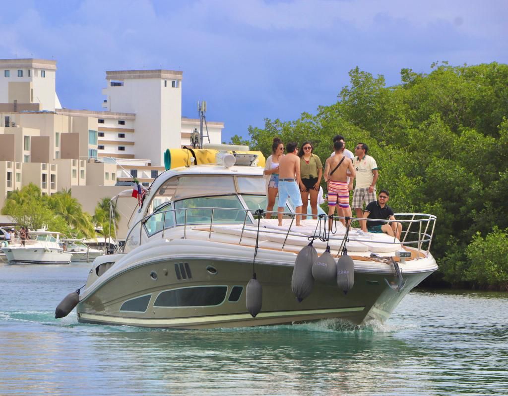 Atenea 46ft yacht cruising in Cancun with guests enjoying the bow