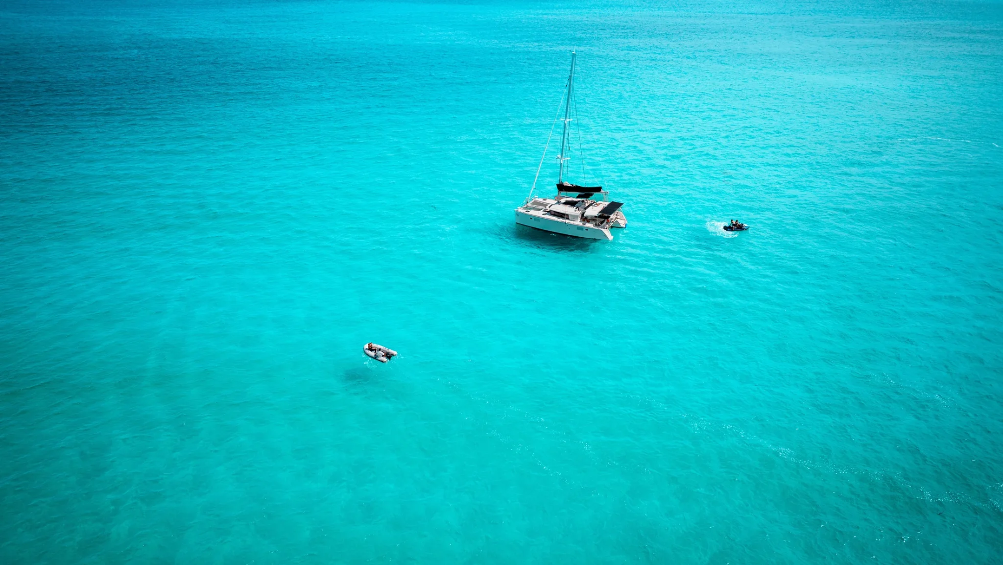 Beluga Catamaran anchored in open turquoise water near Cancun