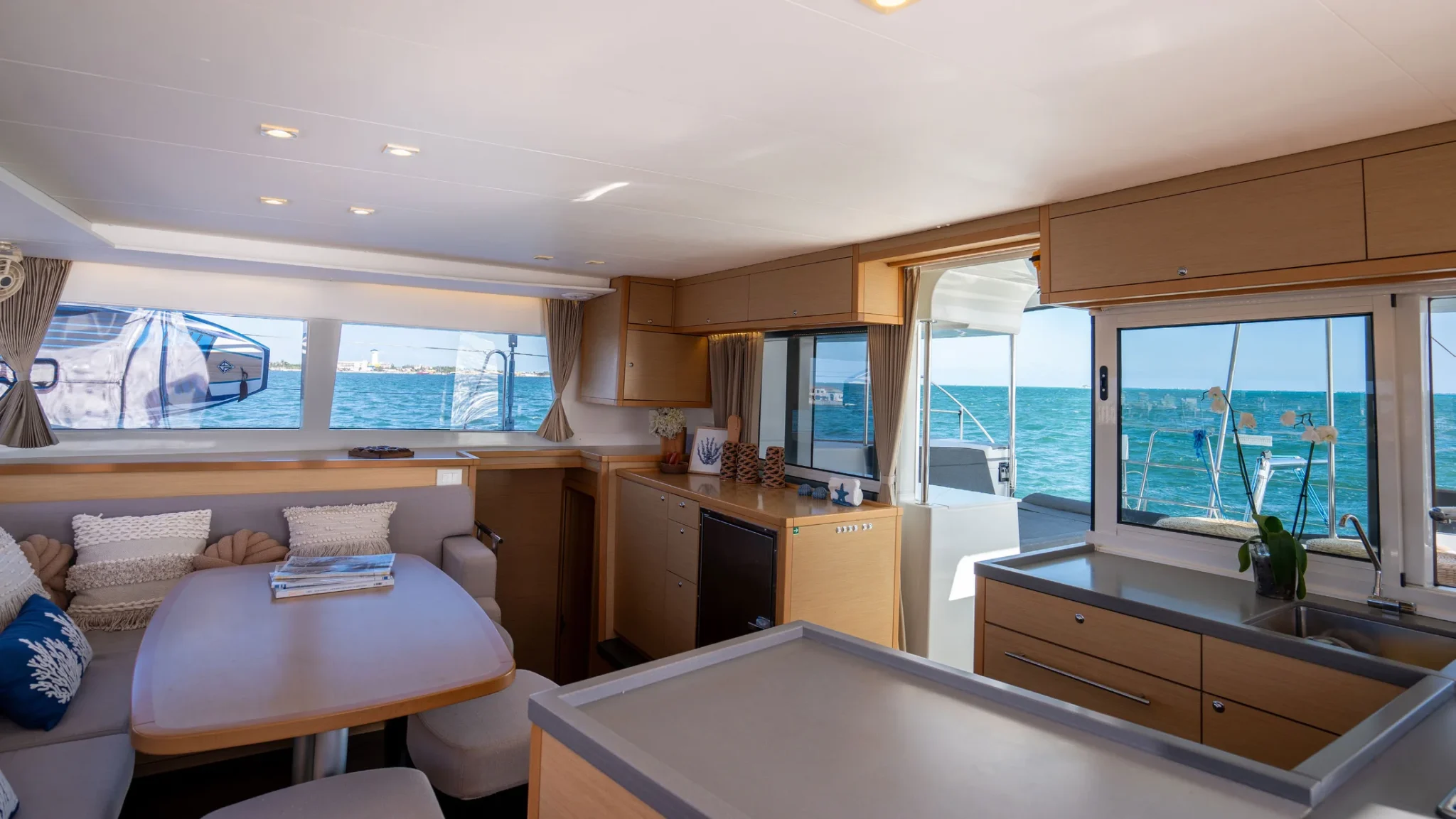 Bright salon and galley interior aboard Beluga Catamaran in Cancun