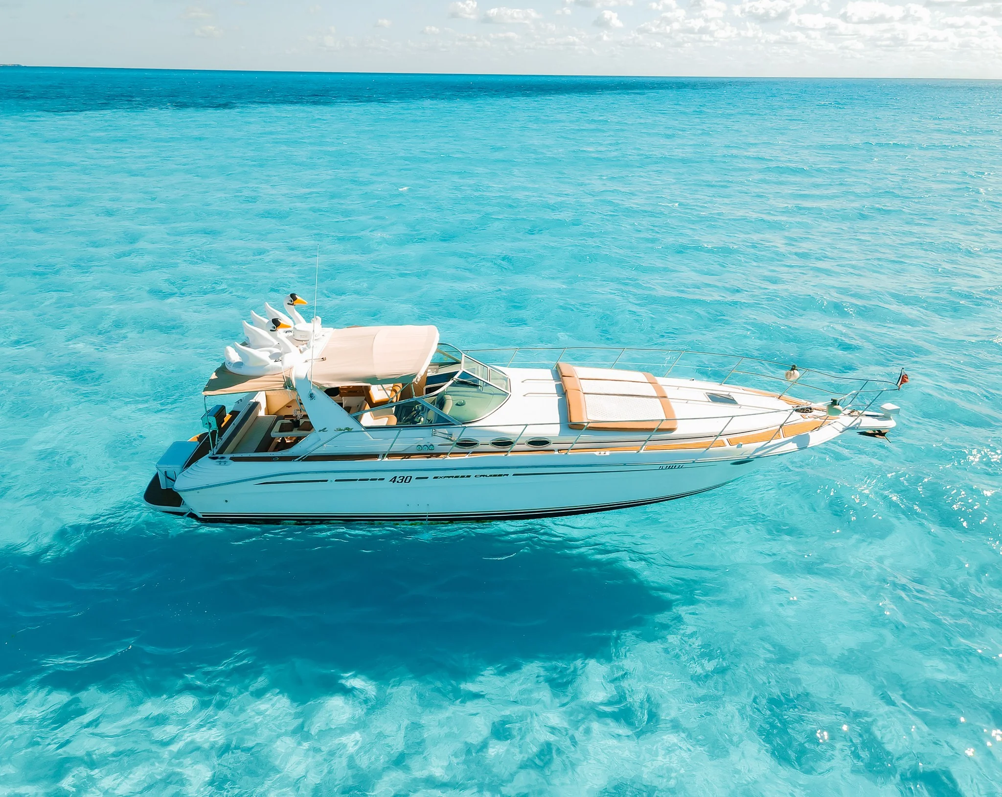 Tata 40ft yacht profile over clear turquoise Cancun water
