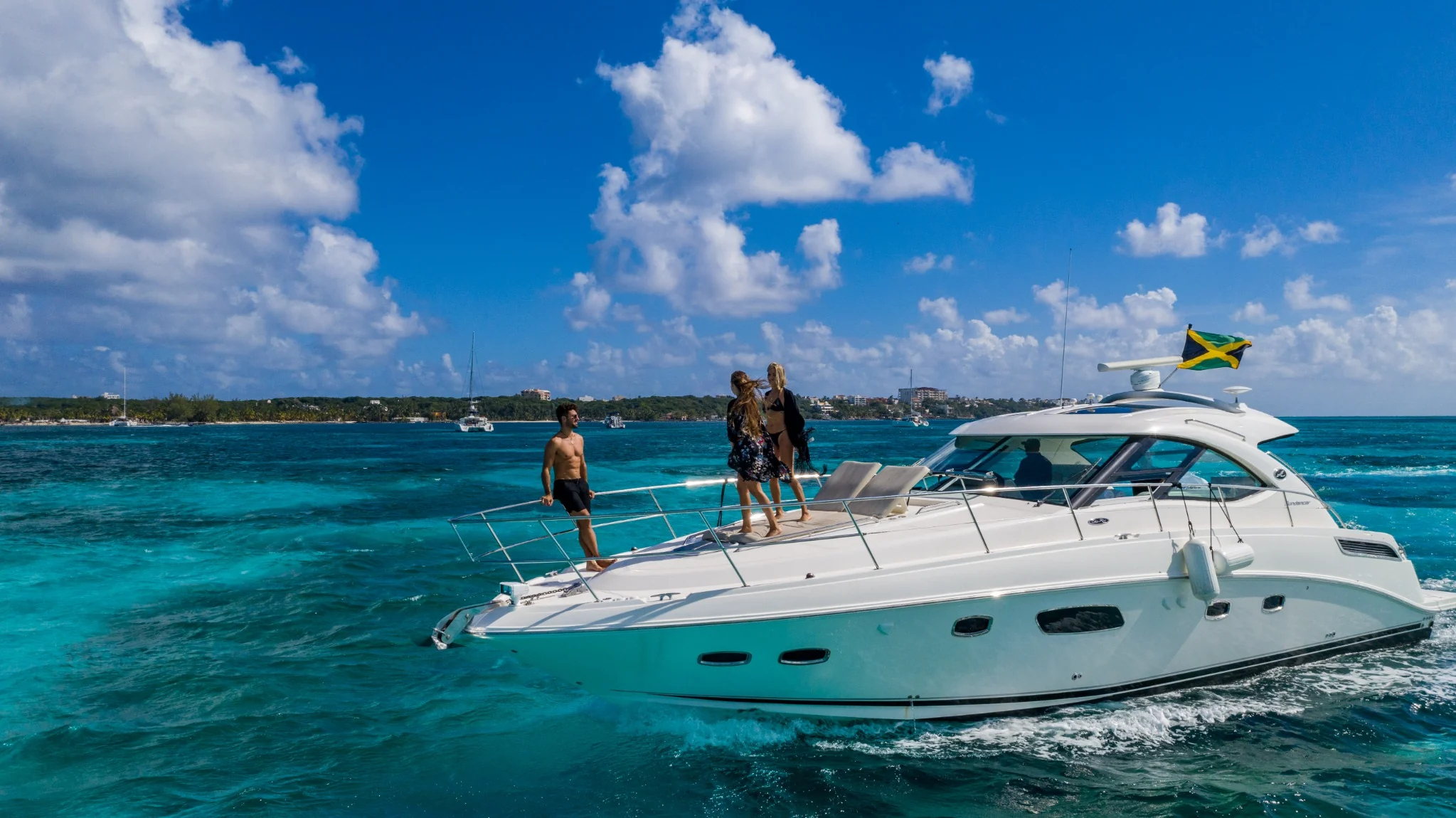Truco IV 47ft Sea Ray yacht cruising in Cancun with guests on bow