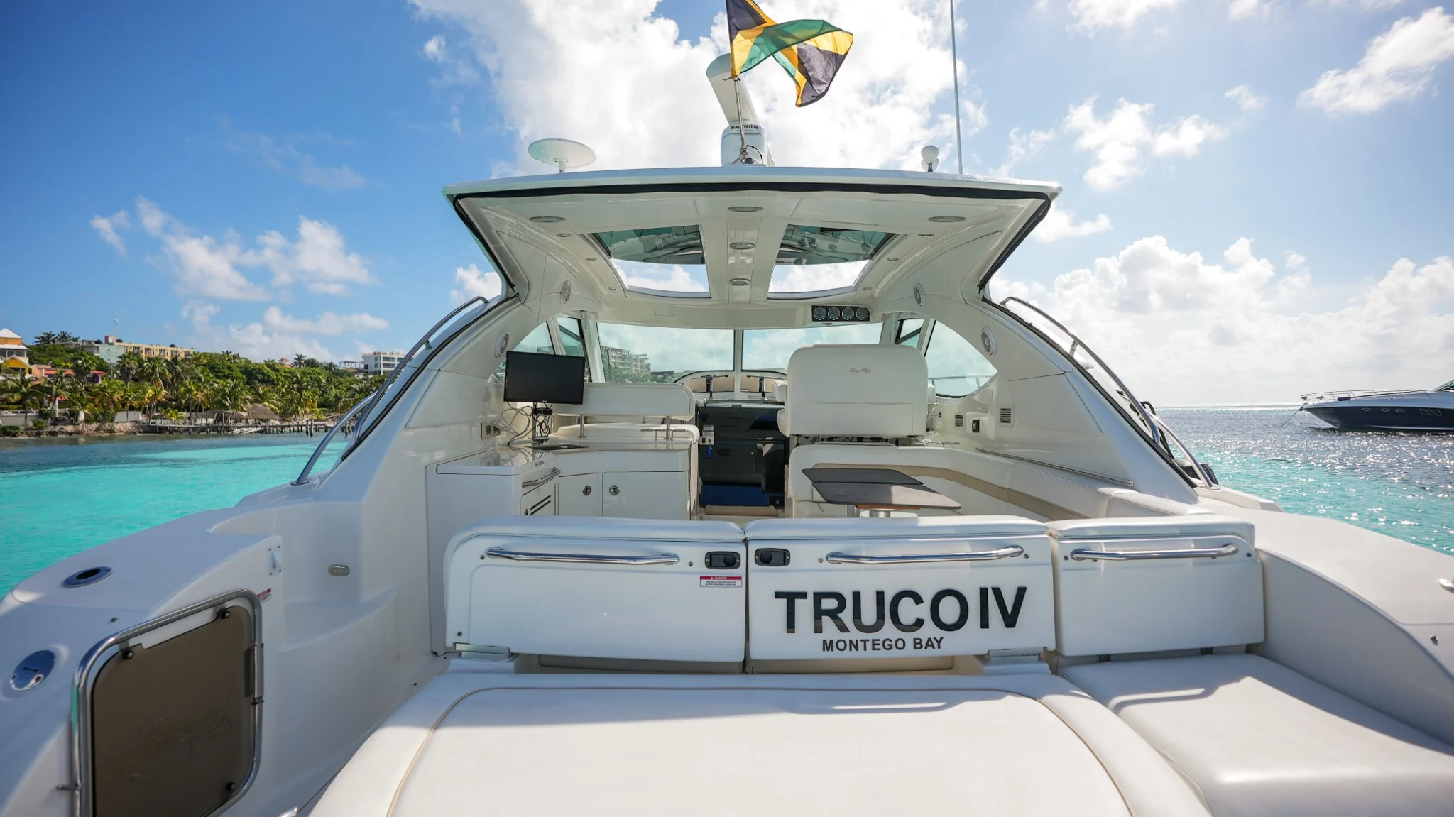 Aft deck nameplate aboard Truco IV 47ft Sea Ray yacht in Cancun