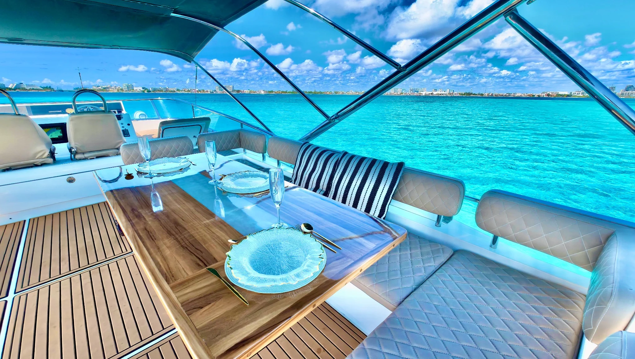 Addicted 70ft flybridge dining with turquoise view