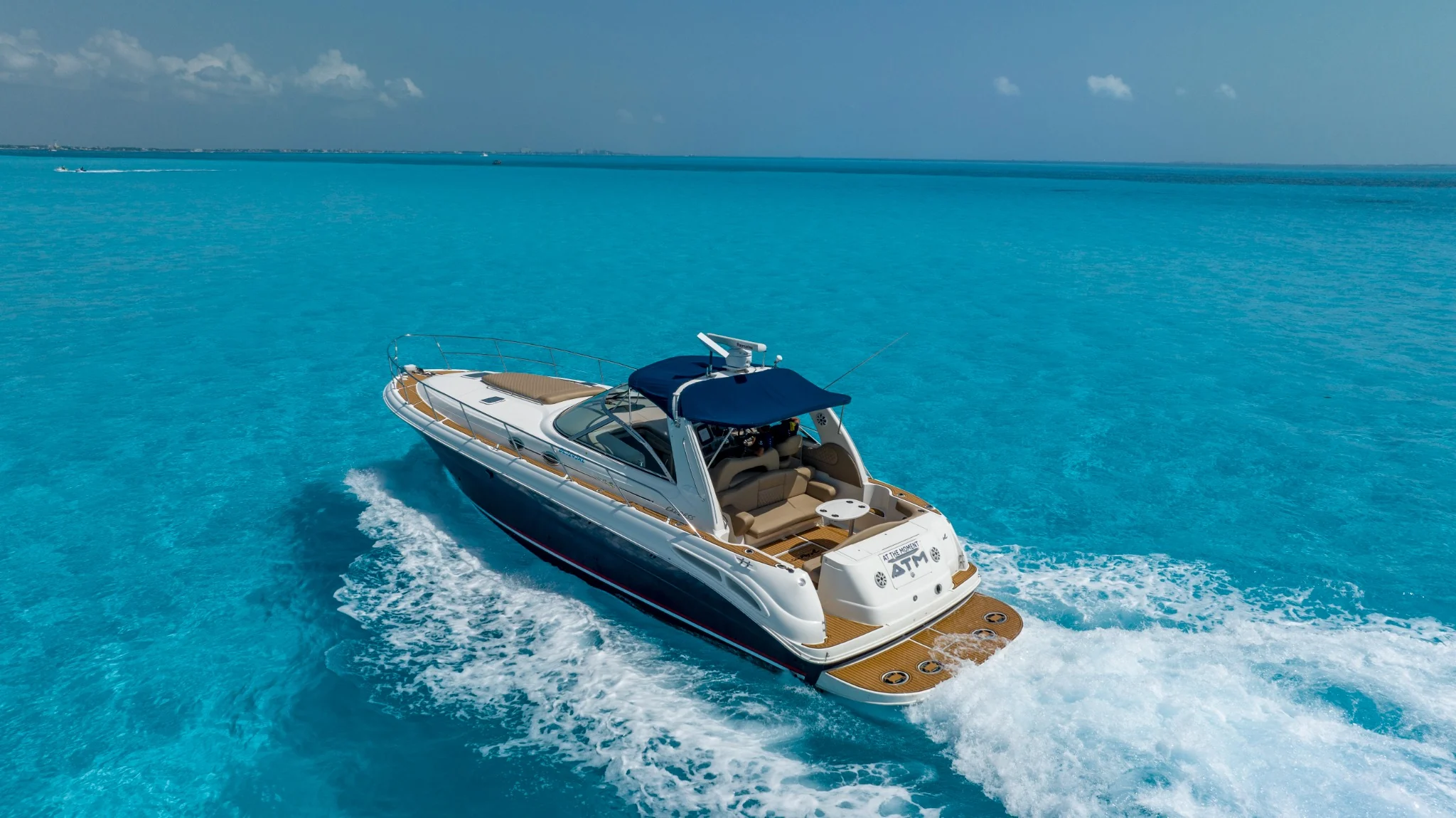 ATM 45ft Sea Ray yacht bow cruising over turquoise Cancun water