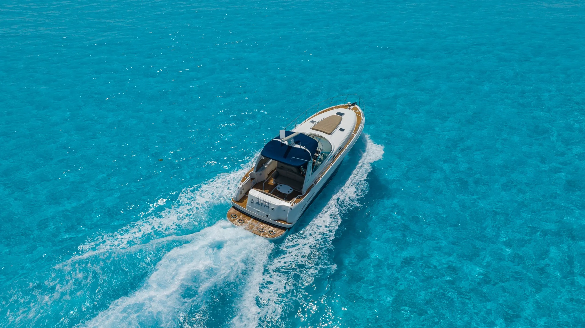 ATM 45ft private yacht charter Cancun stern view on turquoise Caribbean water