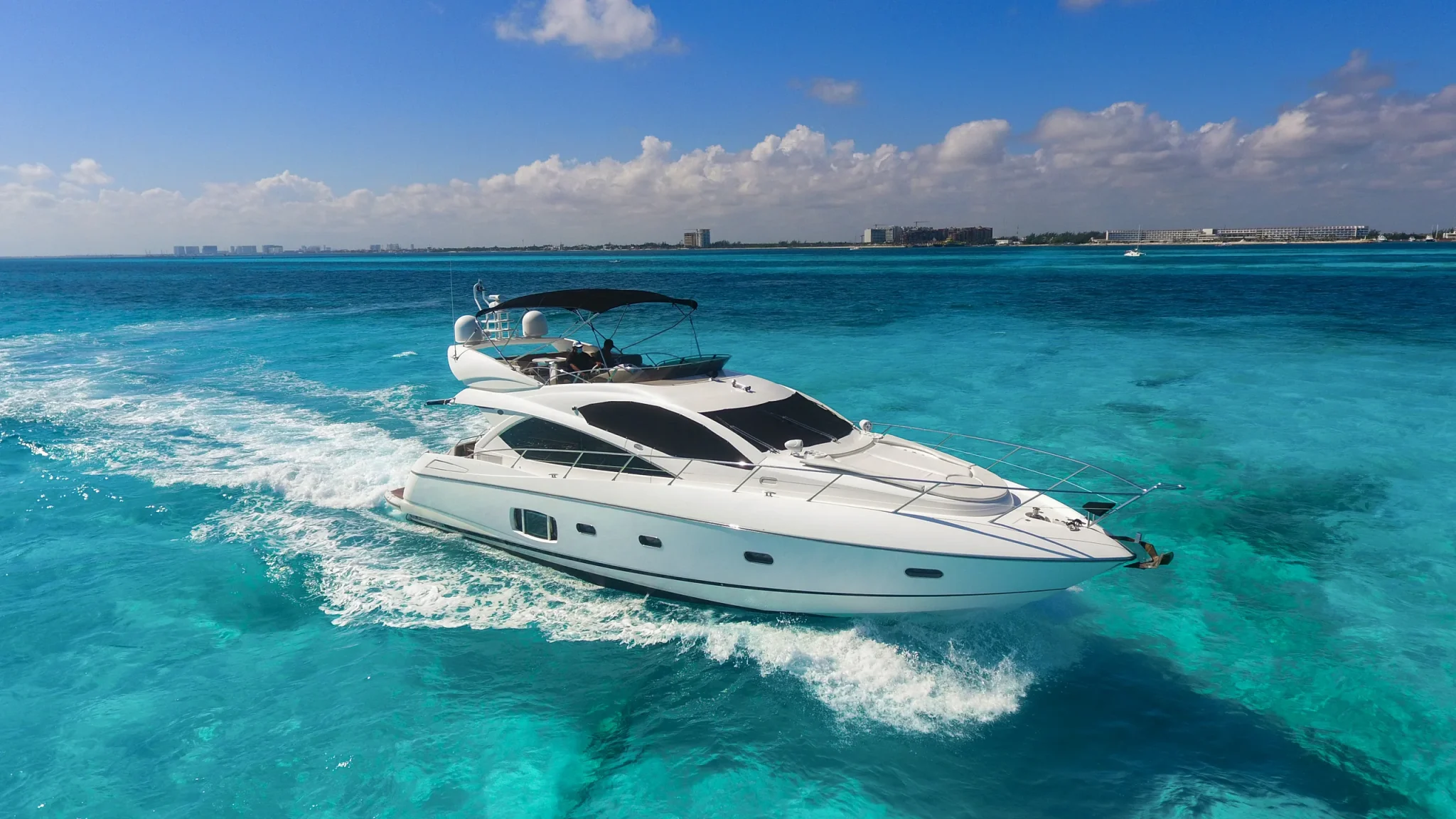 Ave Stella 64ft Sunseeker private yacht charter in Cancun showing aerial bow-quarter cruising view.