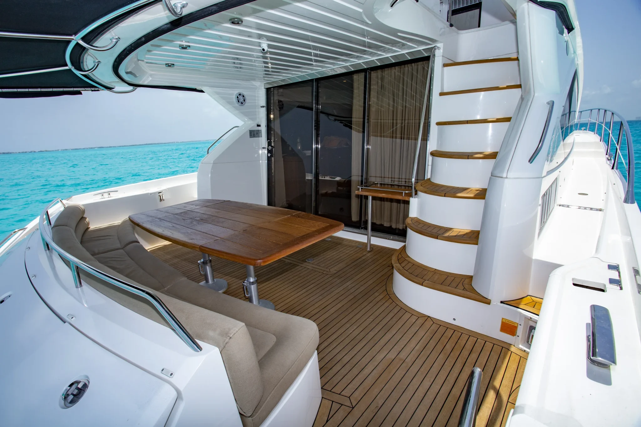 Ave Stella 64ft Sunseeker private yacht charter in Cancun showing aft deck and salon entry.