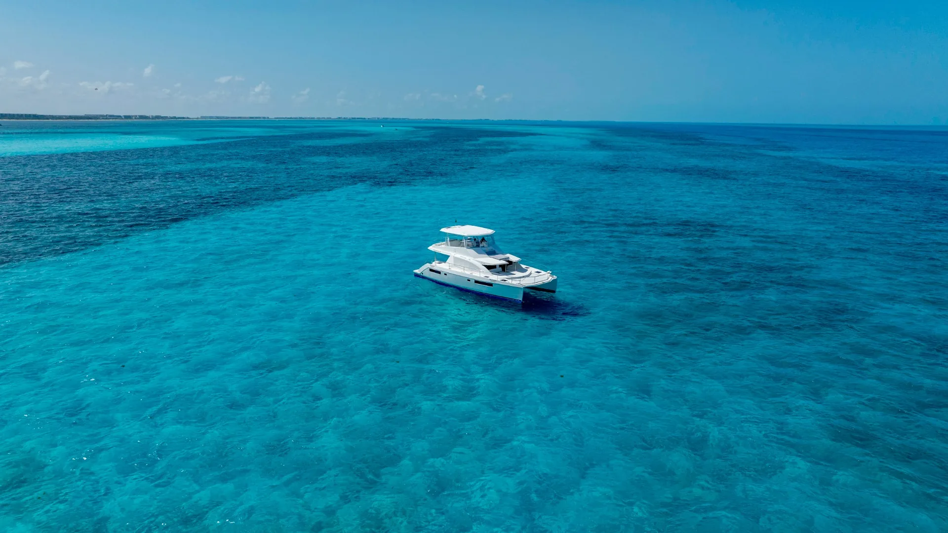Blondie 51ft Leopard wide aerial view over Cancun water