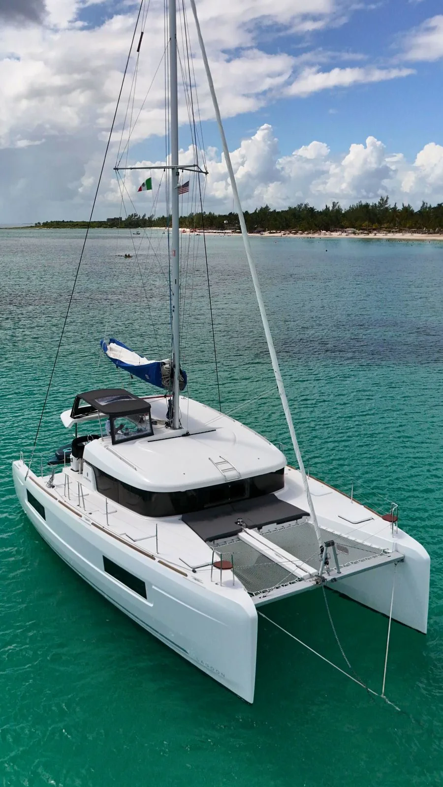 Bow trampoline and deck view of Blue Iris Lagoon catamaran in turquoise water