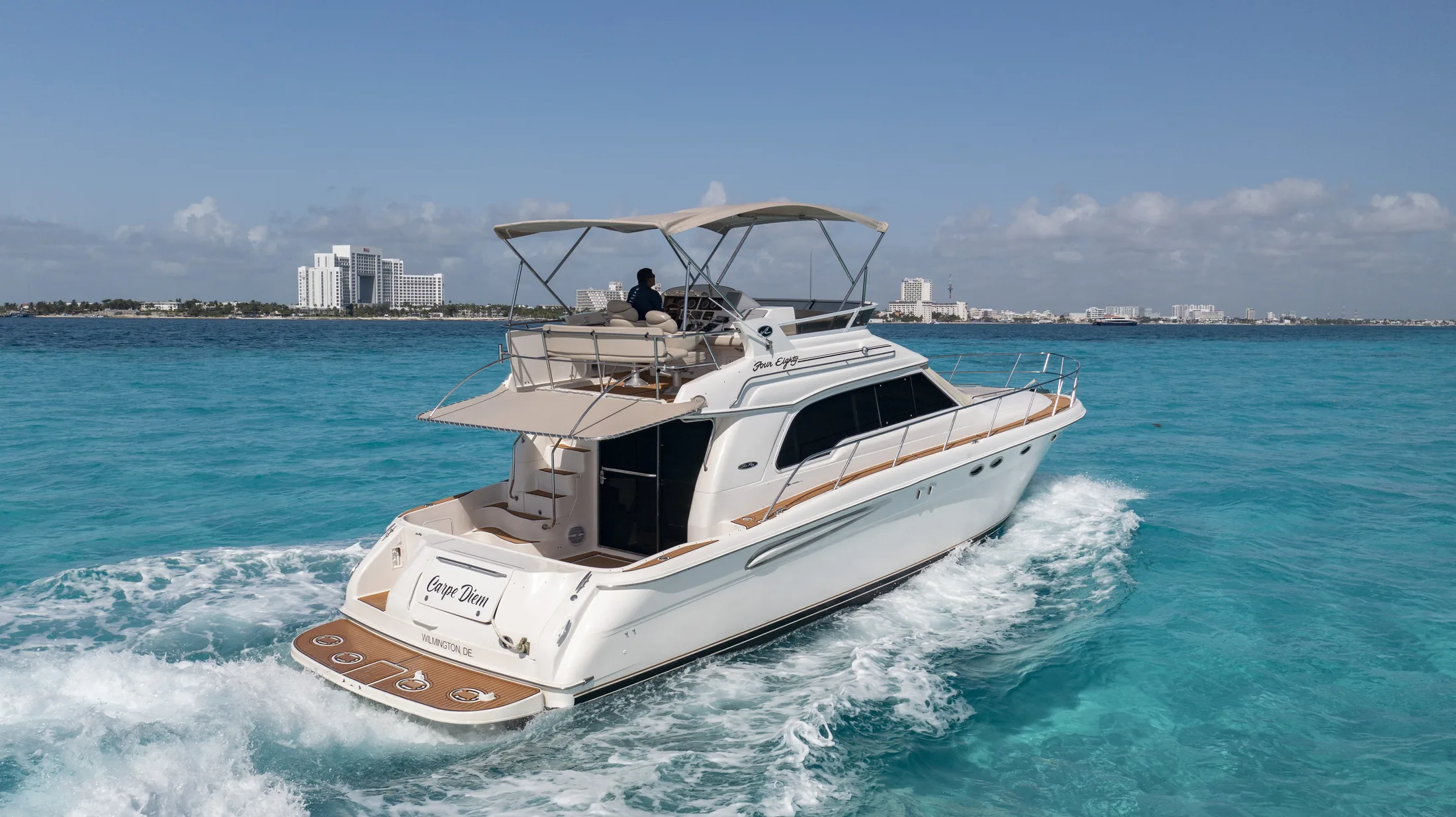 Carpe Diem 52ft Sea Ray private yacht charter in Cancun showing aerial stern-quarter cruising view.