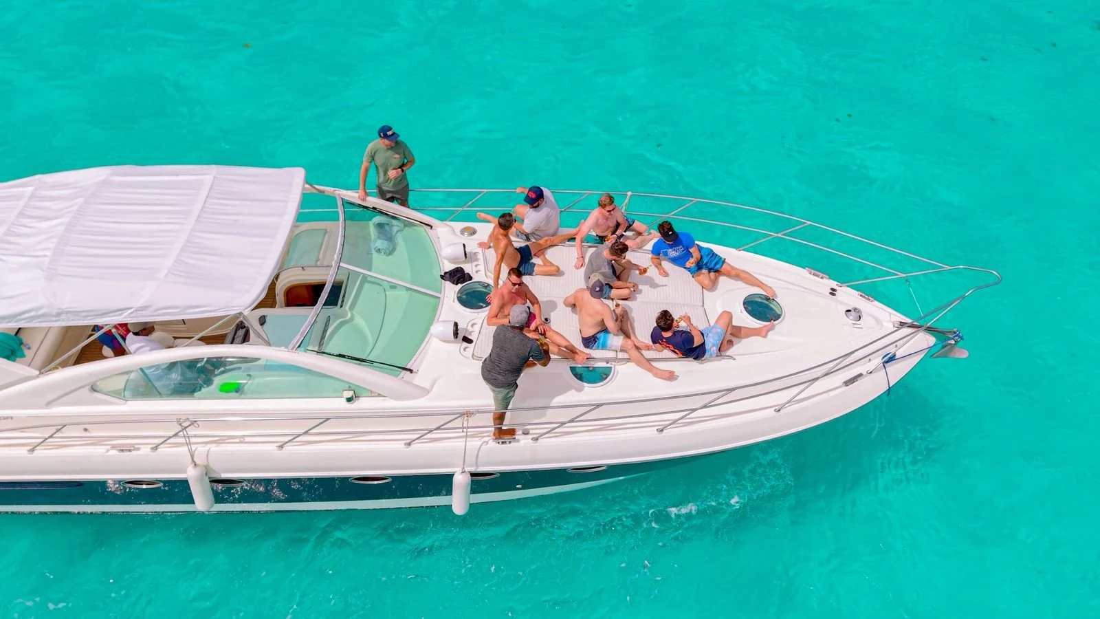 Guests relaxing on the spacious bow lounge of the Nash 52ft yacht while cruising in Cancun.