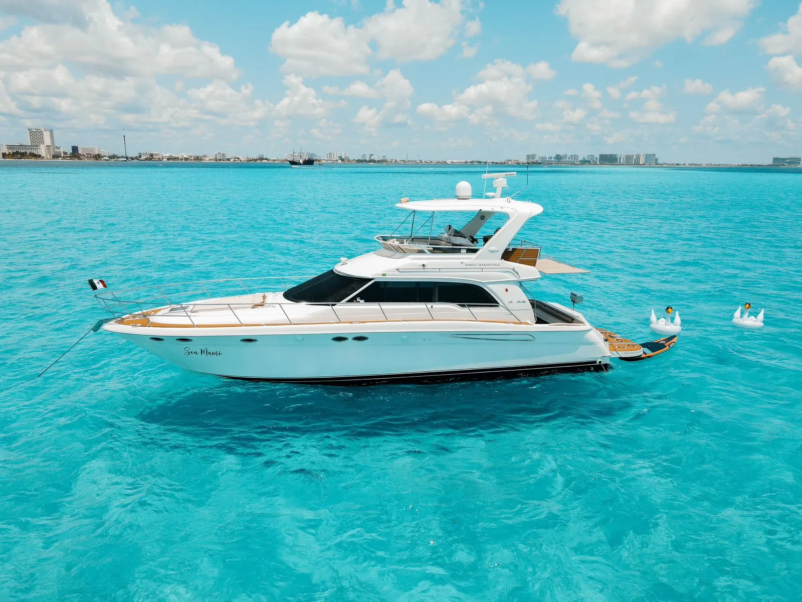Sea Mami private yacht charter side profile in Cancun turquoise
water