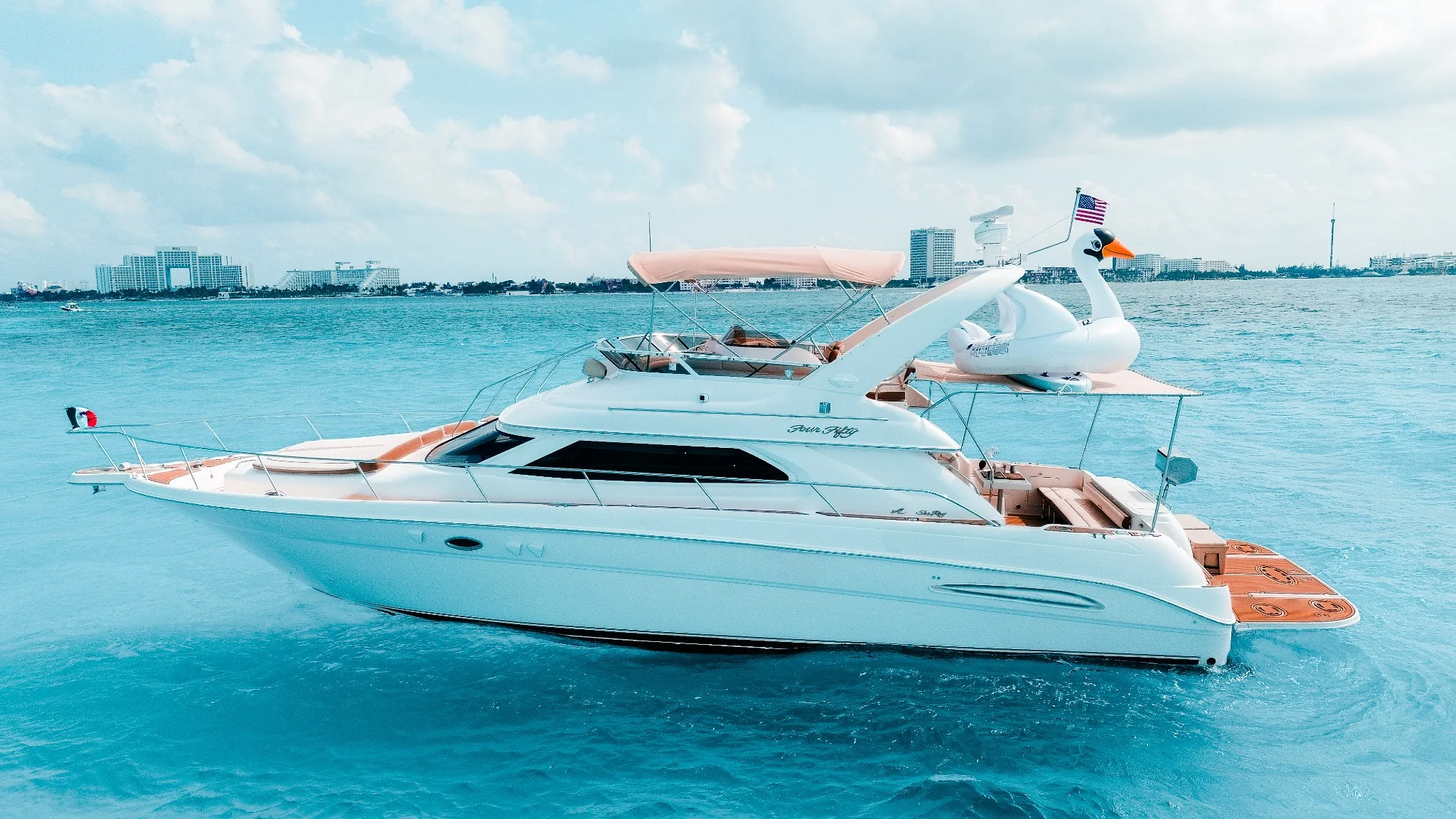 Sea Monkey 50ft Sea Ray side profile cruising in Cancun