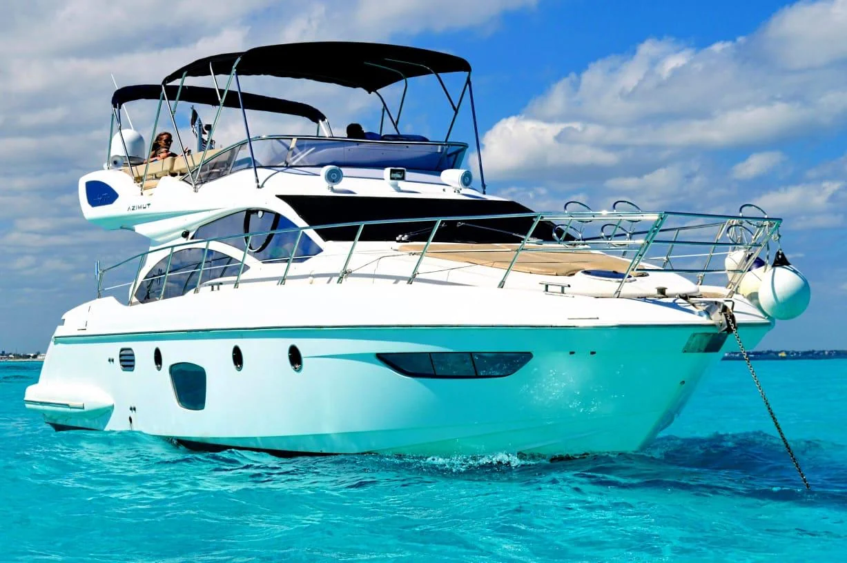 Tatich 48ft luxury yacht front quarter view with bow railings and turquoise sea in Cancun