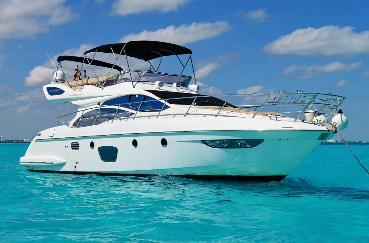 Tatich 48ft Azimut yacht seen from starboard over turquoise Cancun water