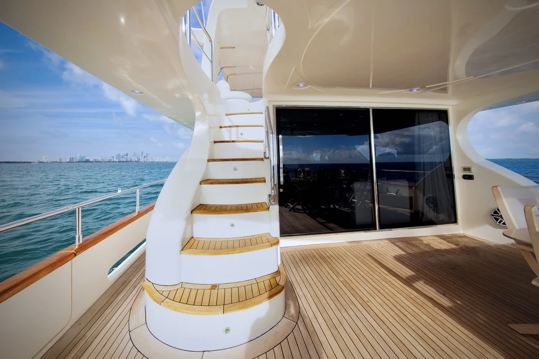 Truco II 80ft yacht aft deck stairs with Cancun skyline in the distance