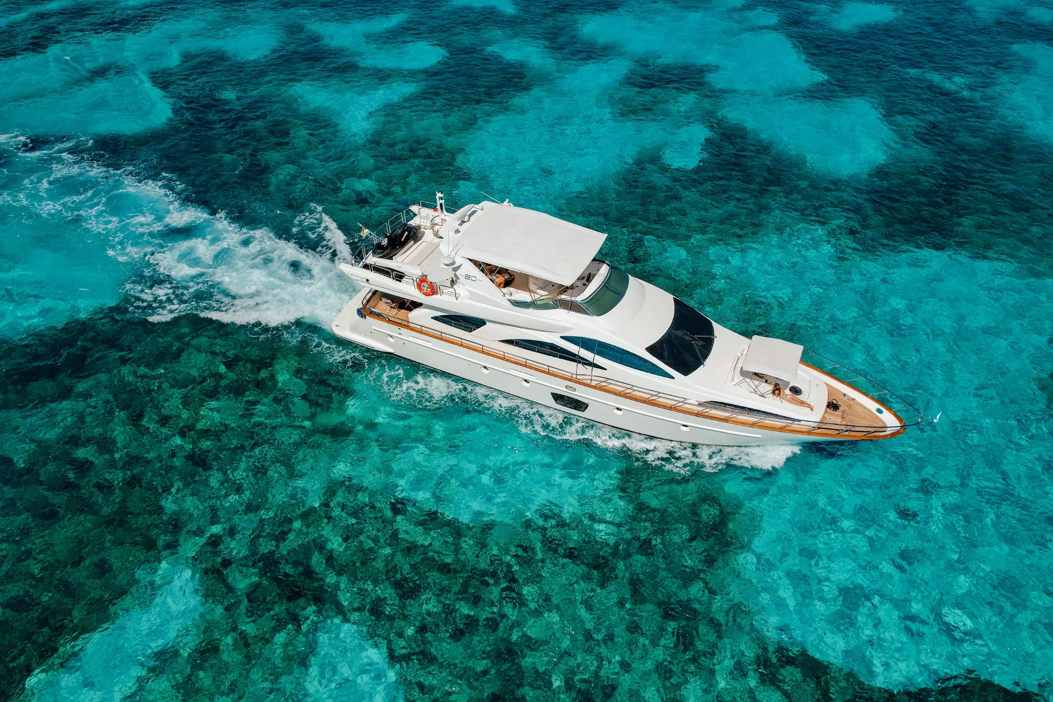 Truco II 80ft private yacht charter Cancun aerial view over turquoise water