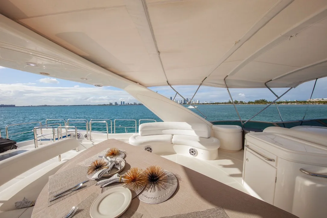 Truco II 80ft yacht flybridge dining table and lounge seating in Cancun
