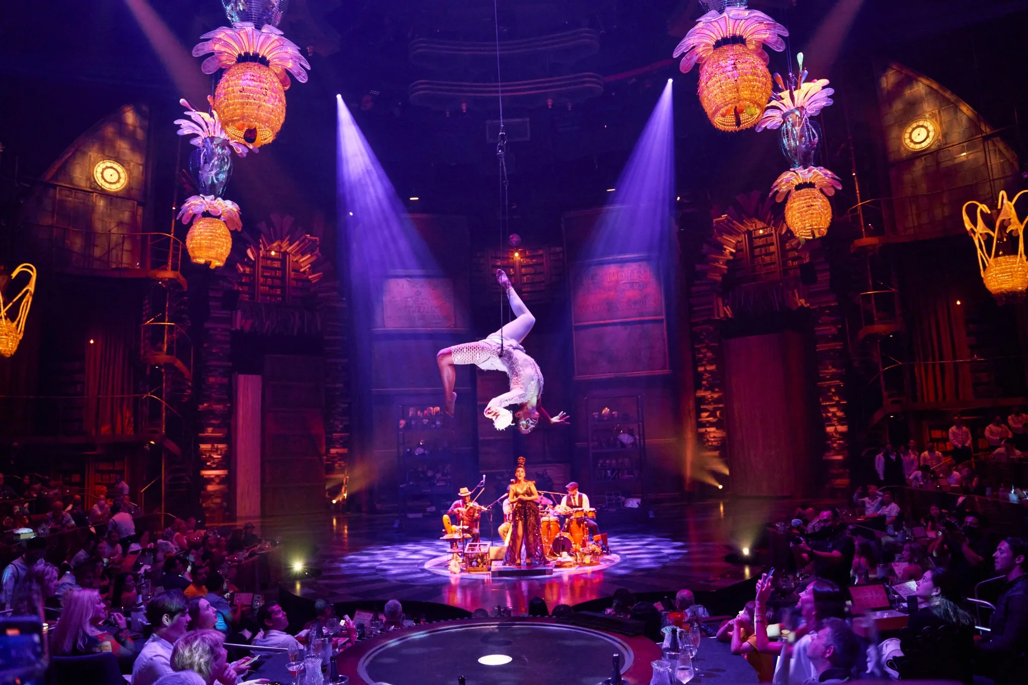 JOYÀ Cirque du Soleil aerial acrobat performing above live musicians and the theatre audience