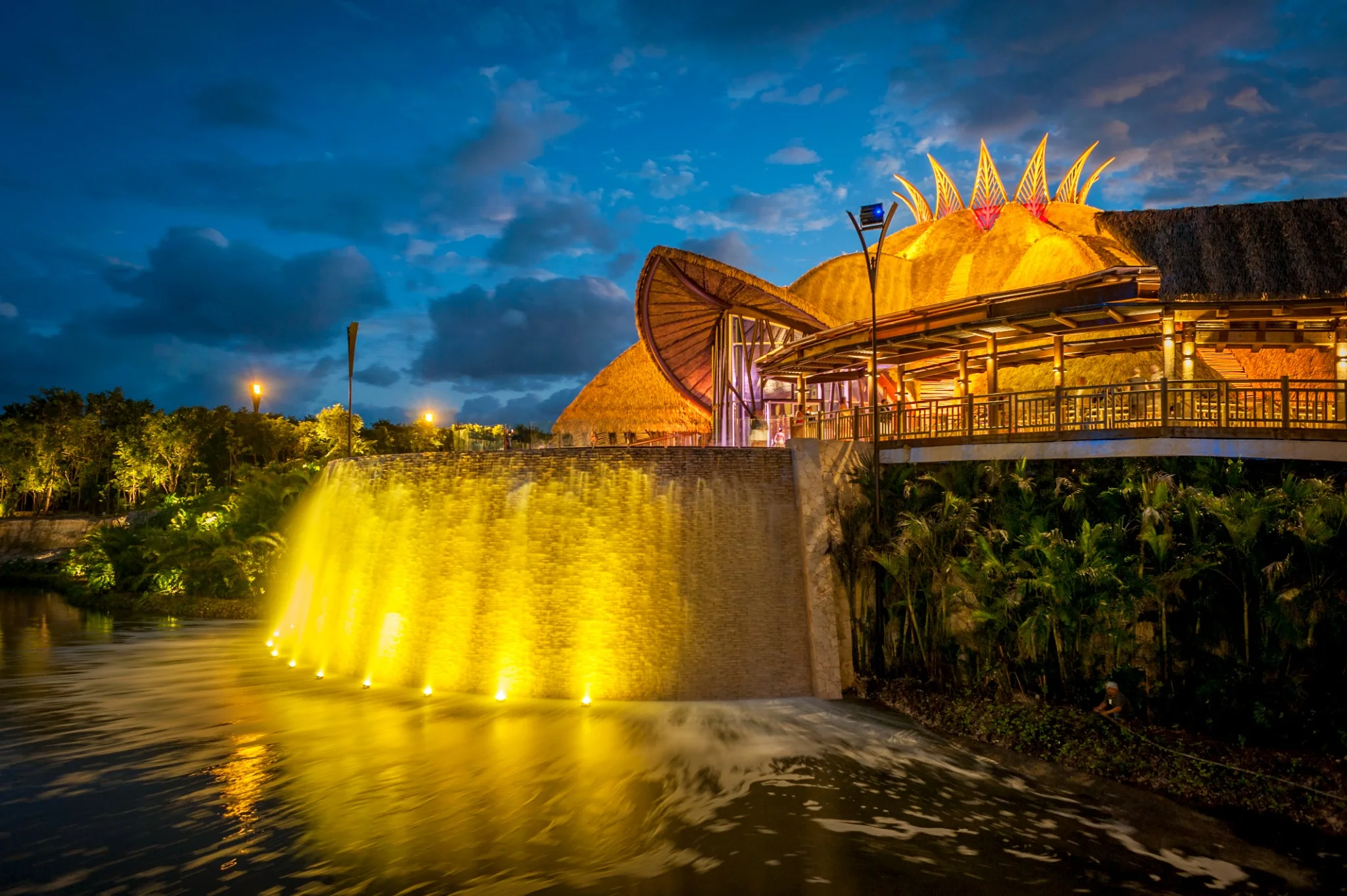 JOYÀ Cirque du Soleil theatre exterior illuminated at dusk in Riviera Maya
