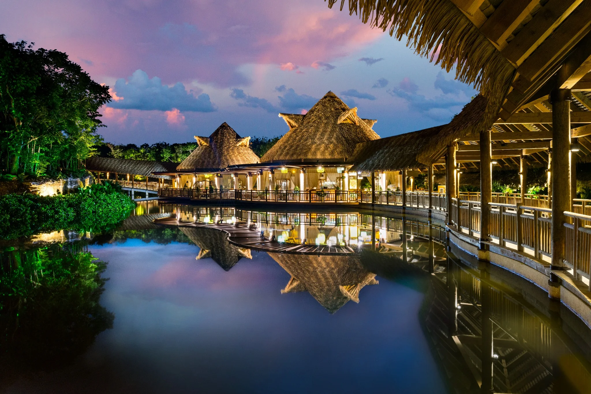 JOYÀ Cirque du Soleil venue reflected in the lagoon at sunset in Riviera Maya