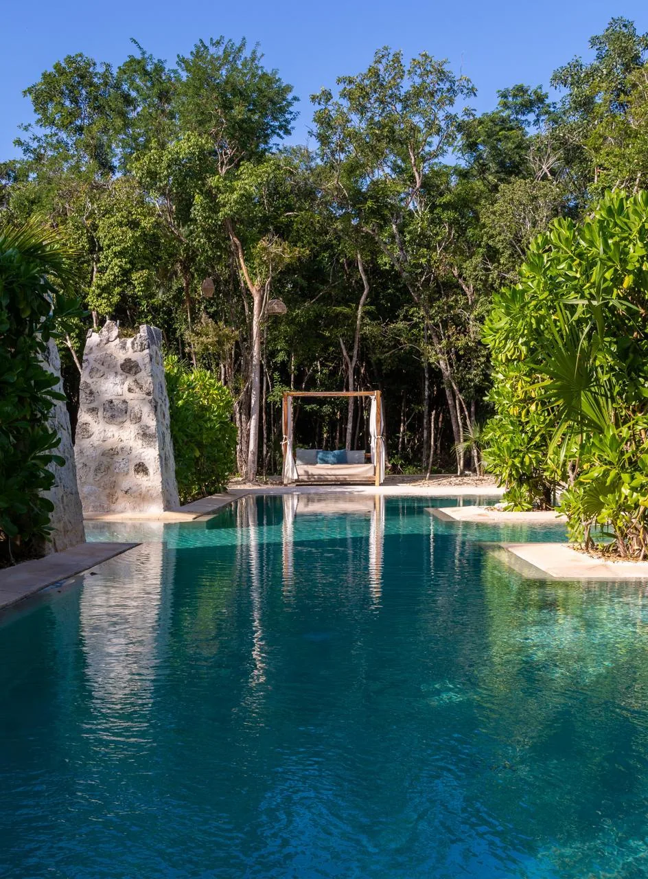 Villa Caiman Tulum private pool with daybed surrounded by jungle