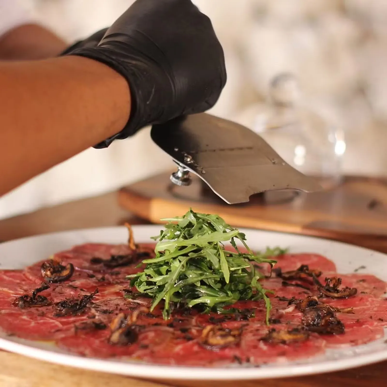 Beef carpaccio presentation with arugula at Taboo Cancun restaurant