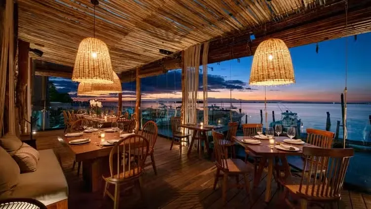 Taboo Cancun terrace dining with lagoon sunset view