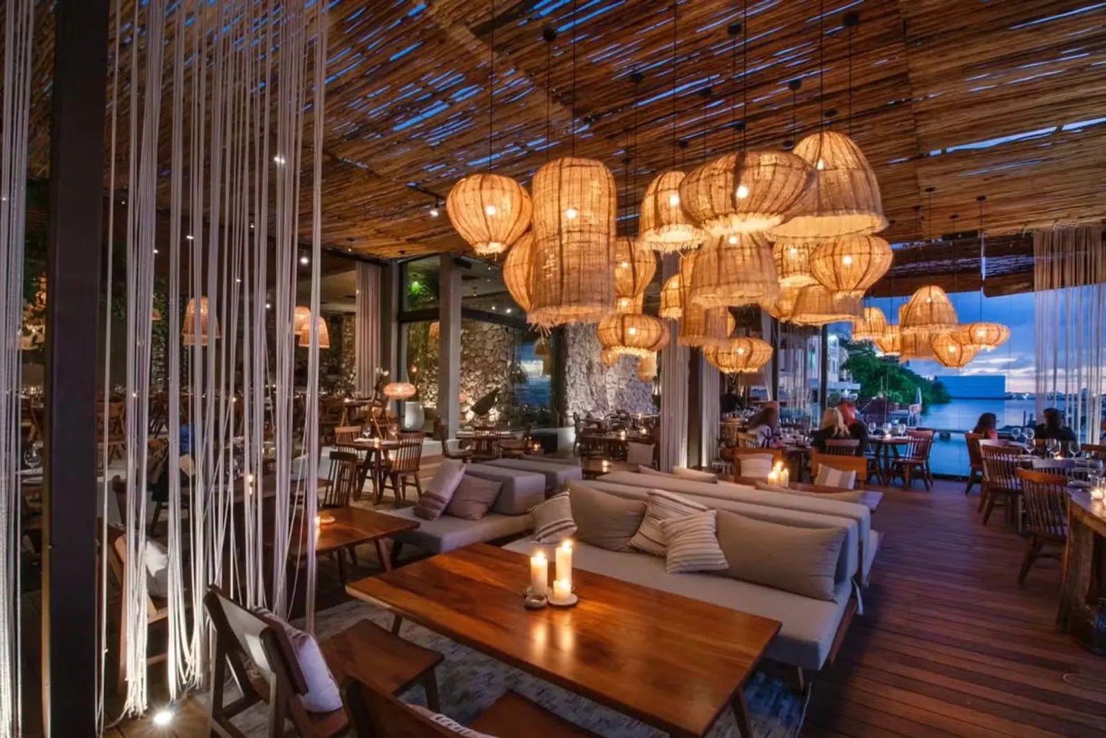 Taboo Cancun restaurant interior with woven lights and waterfront views