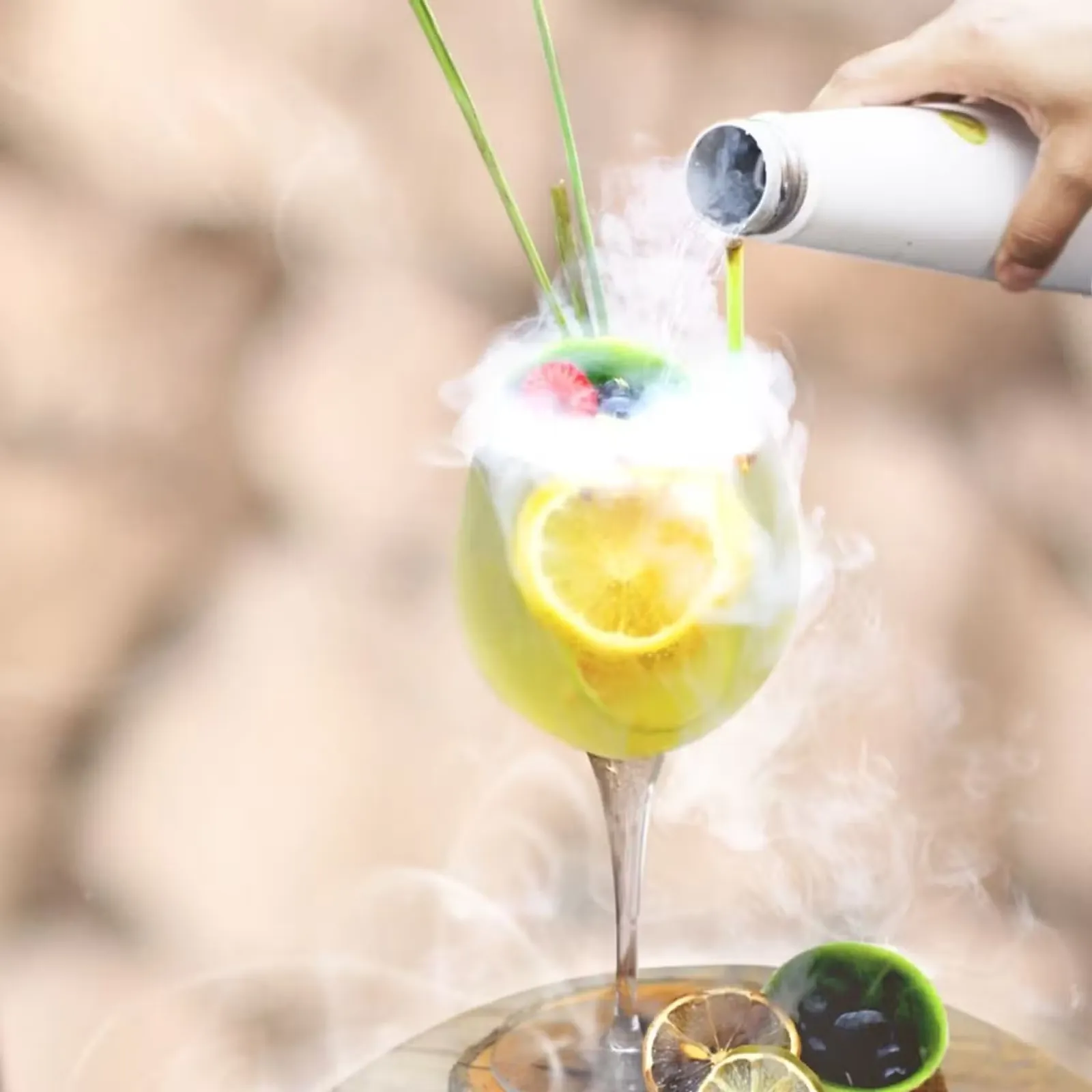 Signature cocktail with citrus and dry ice presentation at Taboo Cancun